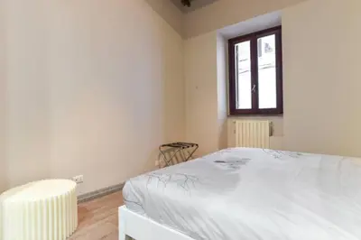 a bedroom with a white bed and a window at Navona Rubens Lodge in Rome