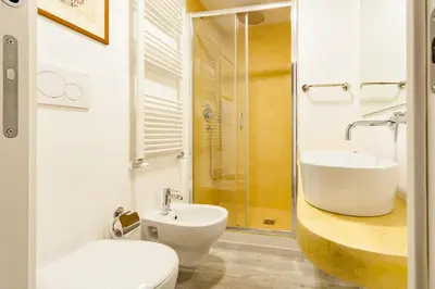 a bathroom with a sink and a toilet and a shower at Trevi Art Suite in Rome