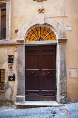 a large wooden door on the side of a building at Trevi Art Suite in Rome