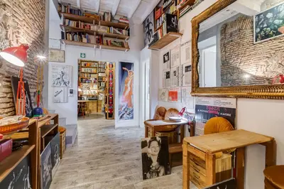 a room with tables and a mirror on the wall at Trevi Art Suite in Rome