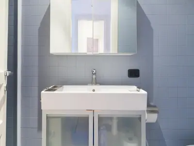 a bathroom with a white sink and a mirror at Sabelli Nightlife Apartment-LA SAPIENZA-TERMINI STATION in Rome