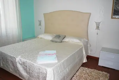 a bedroom with a bed with a white bedspread at San Peter's Corner in Rome