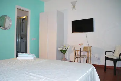 a bedroom with a bed and a tv on the wall at San Peter's Corner in Rome
