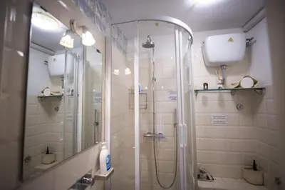 a bathroom with a shower with a glass door at Il Leoncino in Rome