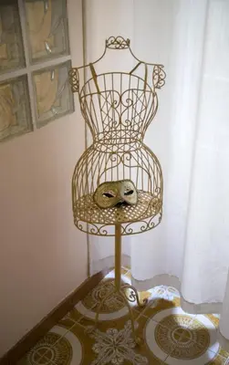 a bird cage sitting on a table in a room at Il Leoncino in Rome
