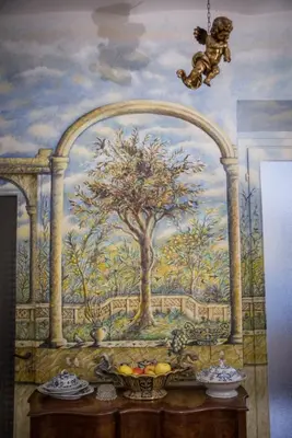 a wall with a painting of a tree at Il Leoncino in Rome