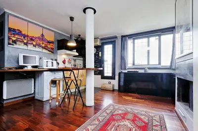 a kitchen with a counter and a bar in a room at Casetta Fleming in Rome