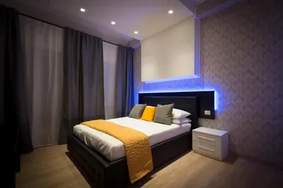 a bedroom with a bed with a blue light at Happy Holiday in Rome b&b in Rome