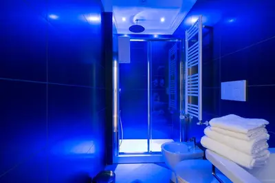 a blue bathroom with a shower and a toilet at Happy Holiday in Rome b&b in Rome