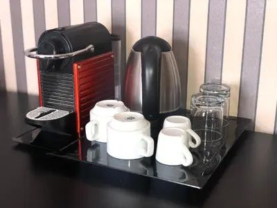 a black shelf with a coffee maker and cups on it at Happy Holiday in Rome b&b in Rome