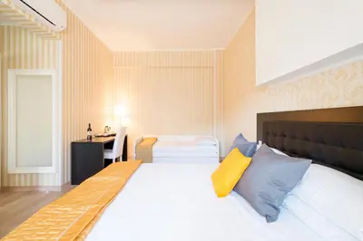 a bedroom with a large bed and a desk at Happy Holiday in Rome b&b in Rome