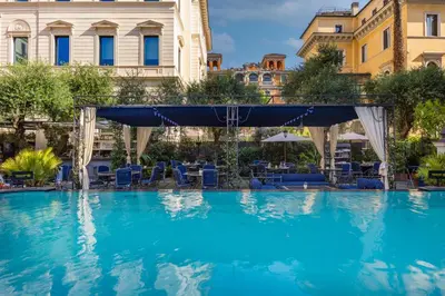 a large swimming pool with a bridge over it at Palazzo Dama - Hotel & SPA - Preferred Hotels & Resorts in Rome