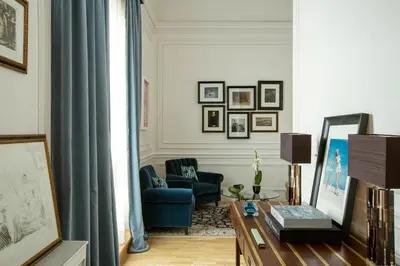 a living room with a blue chair and a table at Palazzo Dama - Hotel & SPA - Preferred Hotels & Resorts in Rome