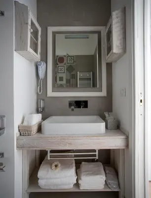 a bathroom with a sink and a mirror and towels at Primo Piano Suites in Rome