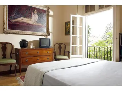 a bedroom with a bed and a dresser and a window at Apartment Margutta in Rome