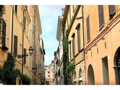 an alley between two buildings in a city at Apartment Margutta in Rome