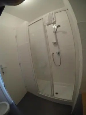 a bathroom with a shower with a glass door at TuttoTondo Roma in Rome