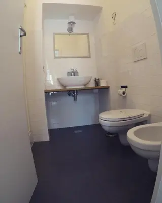 a bathroom with a sink and a toilet at TuttoTondo Roma in Rome