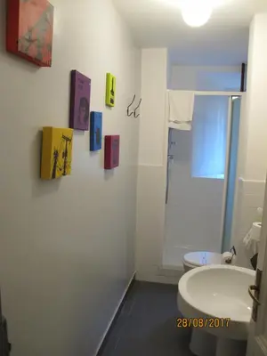 a bathroom with a white toilet and a sink at TuttoTondo Roma in Rome