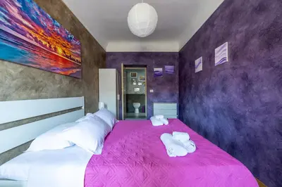 a bedroom with a bed and a table and chairs at Termini Binario 1&2 in Rome