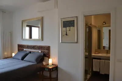 a bedroom with a bed and a bathroom with a mirror at Studio Cardello Colosseum in Rome