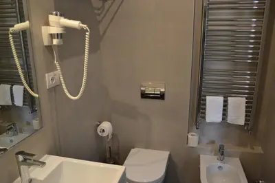 a bathroom with a white toilet and a sink at Studio Cardello Colosseum in Rome