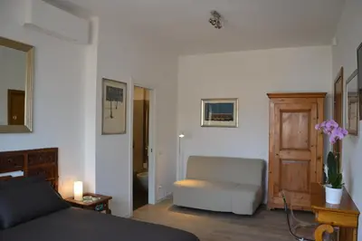 a living room with a couch and a chair at Studio Cardello Colosseum in Rome