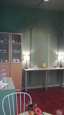 a dining room with trees painted on the wall at Le Tre Sorelle B&b Garbatella in Rome