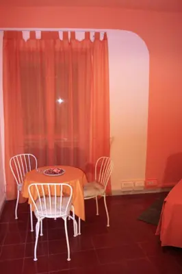 a dining room with a table and two chairs at Le Tre Sorelle B&b Garbatella in Rome