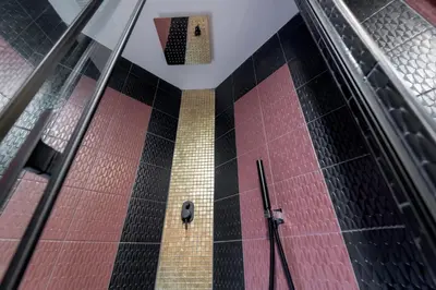 a building with red and black tiles and a clock at St.Peter's Mirror - Romantic View in Rome