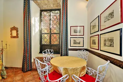 a dining room with a table and chairs and a window at Appartamento Sforza a Monti in Rome