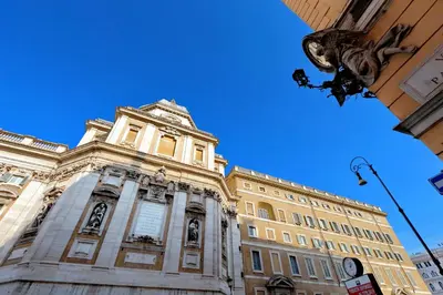 a tall building with a statue in front of it at Appartamento Sforza a Monti in Rome