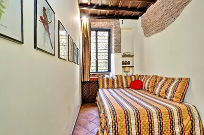 a living room with a couch and a window at Appartamento Sforza a Monti in Rome