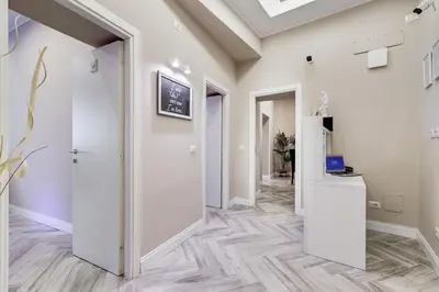 a hallway with white walls and wooden flooring at Hanky Suite in Rome