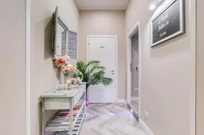 a hallway with a table with flowers on it at Hanky Suite in Rome