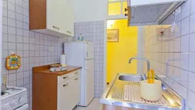 a small kitchen with a sink and a refrigerator at Rental in Rome Sardegna Apartment in Rome