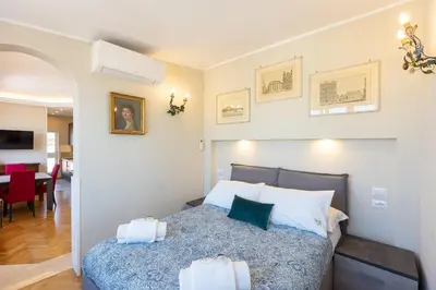 a bedroom with a bed and a dining room at Argentina Penthouse by Rental in Rome in Rome
