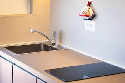 a kitchen with a sink and a counter top at Argentina Penthouse by Rental in Rome in Rome