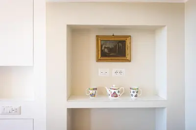 a shelf in a room with two mugs on it at Argentina Penthouse by Rental in Rome in Rome
