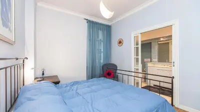 a bedroom with a blue bed and a balcony at Rental in Rome Risorgimento view Aparment in Rome