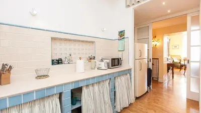 a kitchen with a counter with a microwave and a refrigerator at Rental in Rome Risorgimento view Aparment in Rome