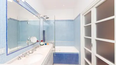 a bathroom with a tub and a sink and a mirror at Rental in Rome Risorgimento view Aparment in Rome