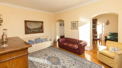 a living room with a couch and a table and chairs at Rental in Rome Risorgimento view Aparment in Rome