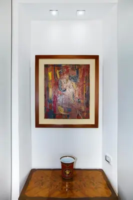 a painting on a wall next to a table with a bowl at PgrHome Parione in Rome