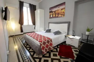a bedroom with a bed with a red blanket on it at Casa Dania in Rome