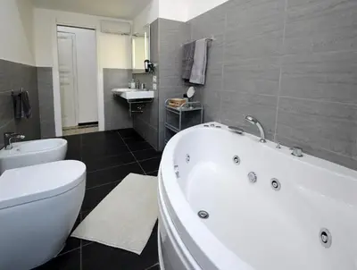 a bathroom with a tub and a toilet and a sink at Casa Dania in Rome