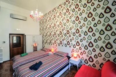 a bedroom with a bed and a large wall at Da Augusto in Rome