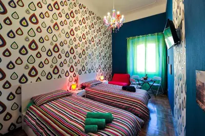 a bedroom with a bed and a red chair at Da Augusto in Rome