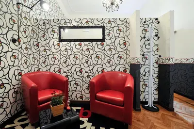 two red chairs and a mirror in a room at Da Augusto in Rome