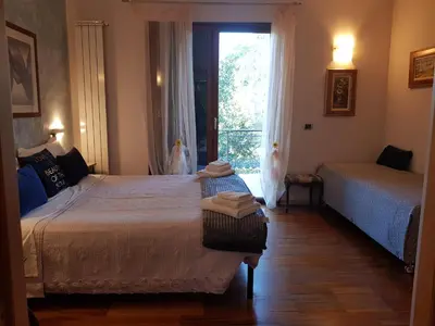 a bedroom with two beds and a window at Aurelia Garden Gold B&B in Rome